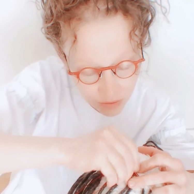 Ksenia Shinkovskaya working on installing the elements into one of her artworks